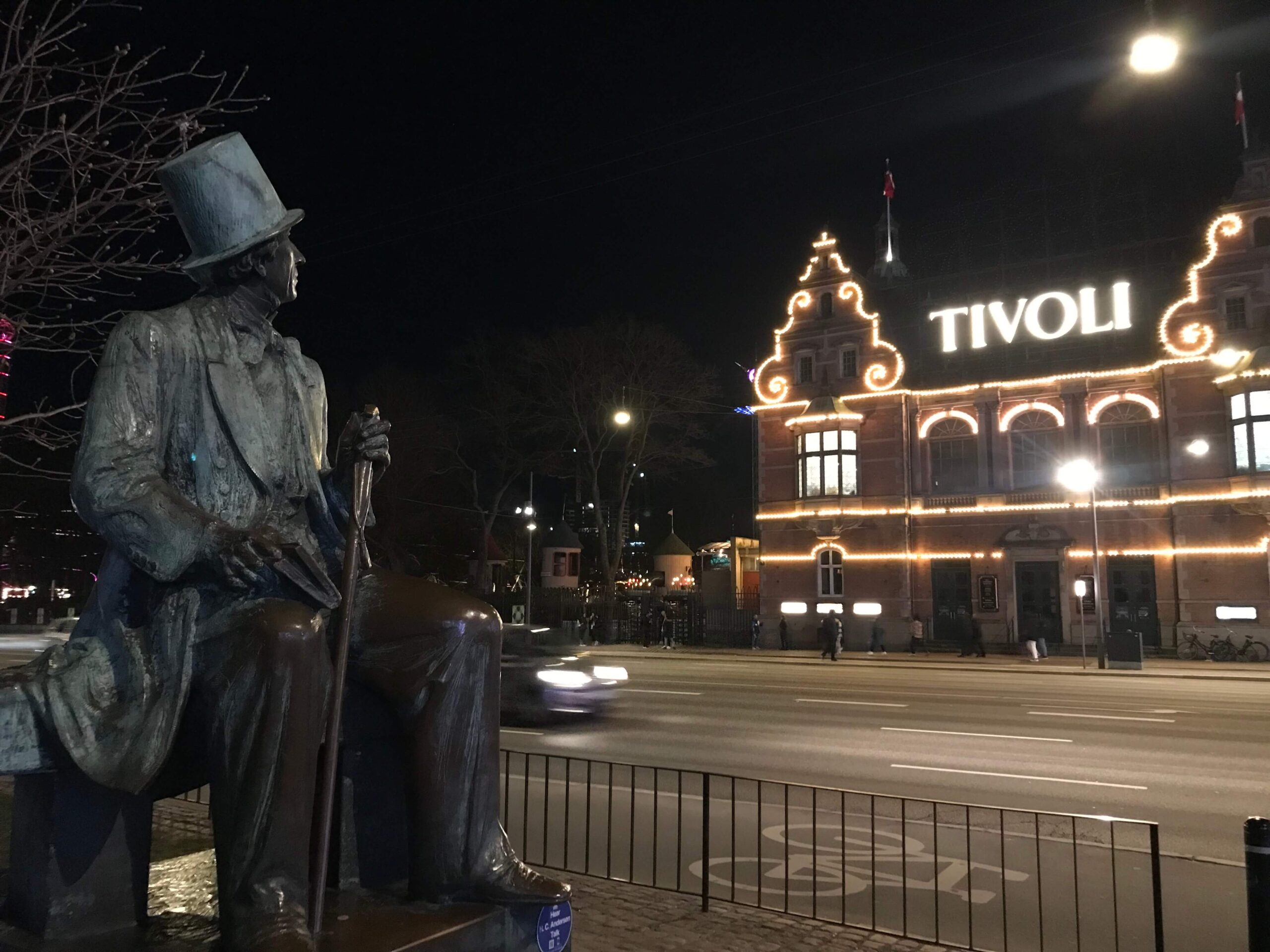 the statue of H.C. Andersen looking at the sign of Tivoli, Copenhagen